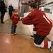 Two-year-old Travis Raschke gives his father Jason a fist bump in between periods.
Courtney Sacco I AnnArbor.com 